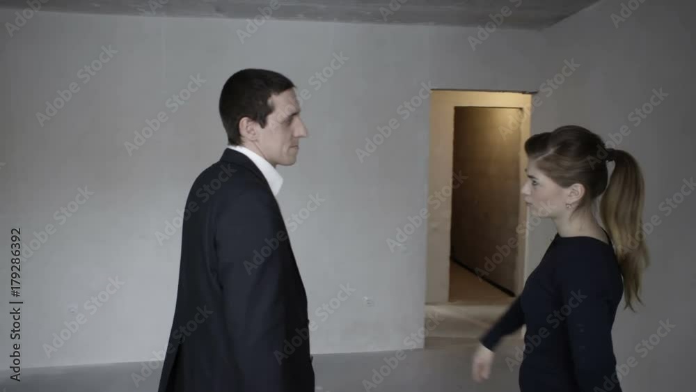 Real estate agent walks around the new apartment and communicates with the client Real estate agent walks around the new apartment and communicates with the client