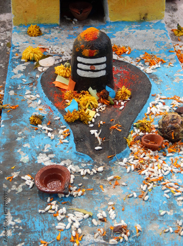 Hindu people decorate tombstone with Shiva linga and offer sweets,fruits on Diwali festival as remembrance day 