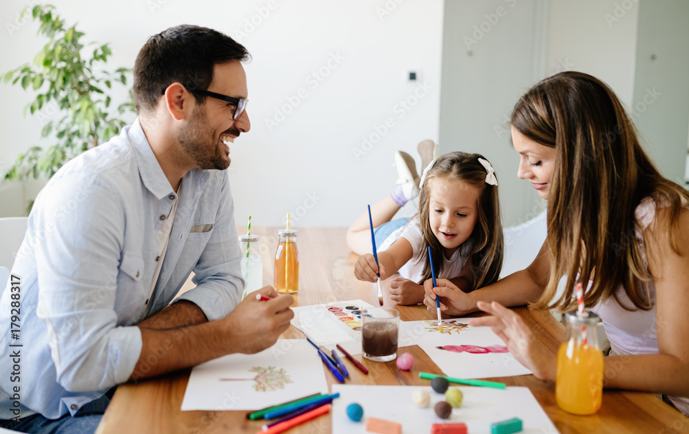 Happy familiy spending fun time at home Happy familiy spending fun time at home