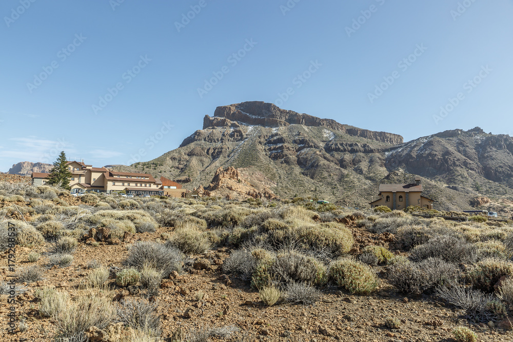 Landscape of rocky and arid zone with some buildings