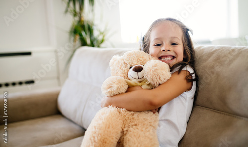 Obraz na płótnie Cute little girl playing with teddy bear