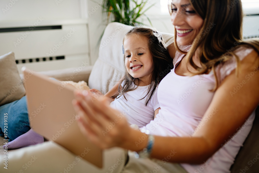 Happy mother with her daughter using digital tablet Happy mother with her daughter using digital tablet