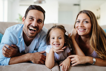 Happy family watching television at their home