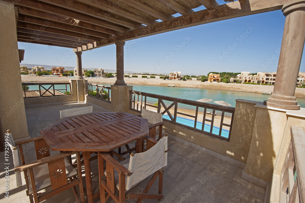 Fototapeta premium Terrace balcony with chairs and table at tropical luxury apartment