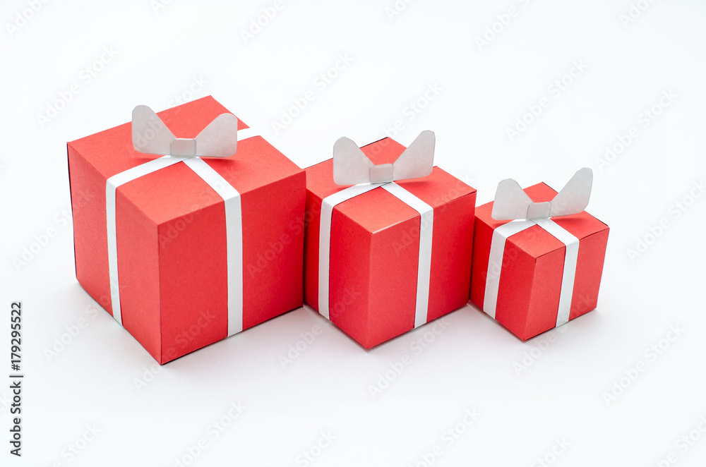 Three miniature red gift boxes on the white background
