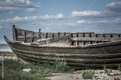 An old wooden boat on the shore of the estuary in the village near the Black Sea