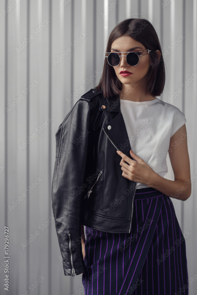 Fototapeta premium Young beautiful woman in a black jacket 