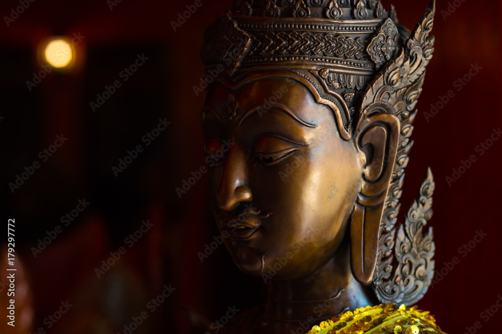 Dark face of Buddha.Buddha statue face close up