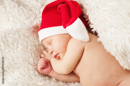 A baby in a Santa Claus hat © liyasov