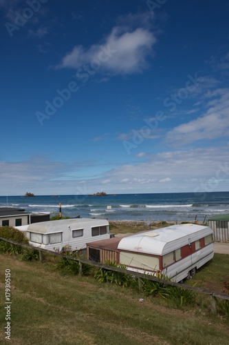Hawke's bay  cape kidnappers coast New Zealand. Coast and beach with trailerpark. Caravans photo