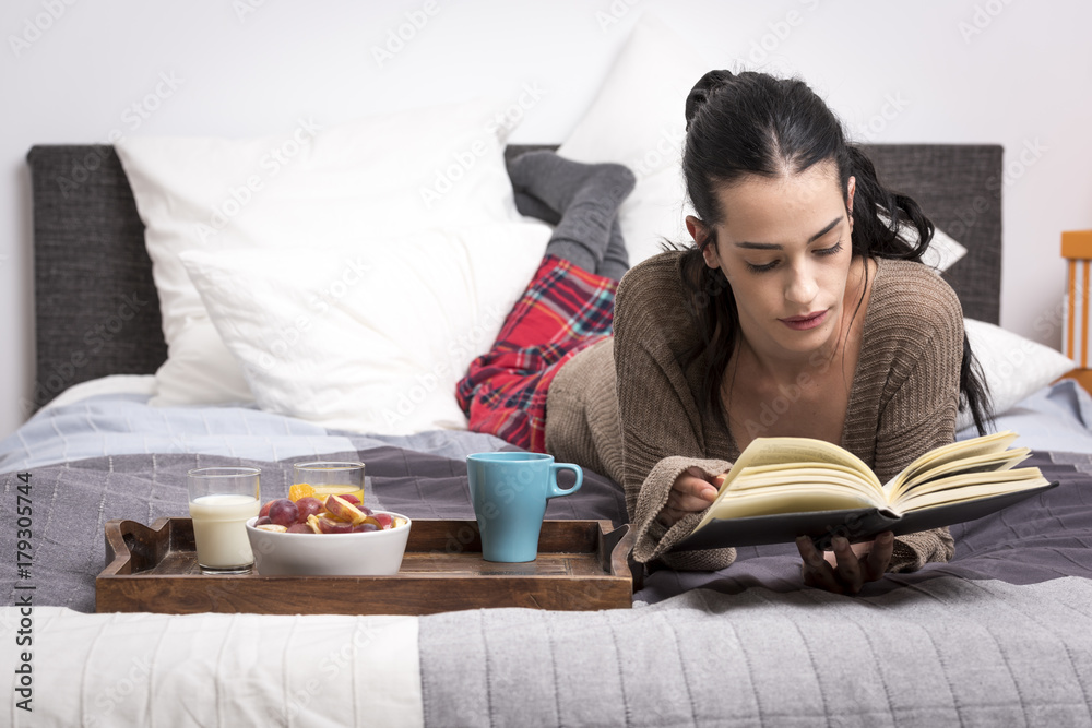Woman lounging n bed with snacks