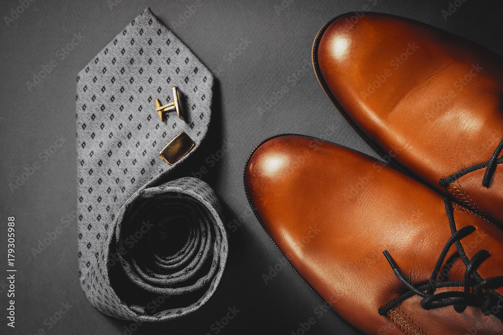 Obraz premium Accessories for mens. Brown shoes with tie and cuff