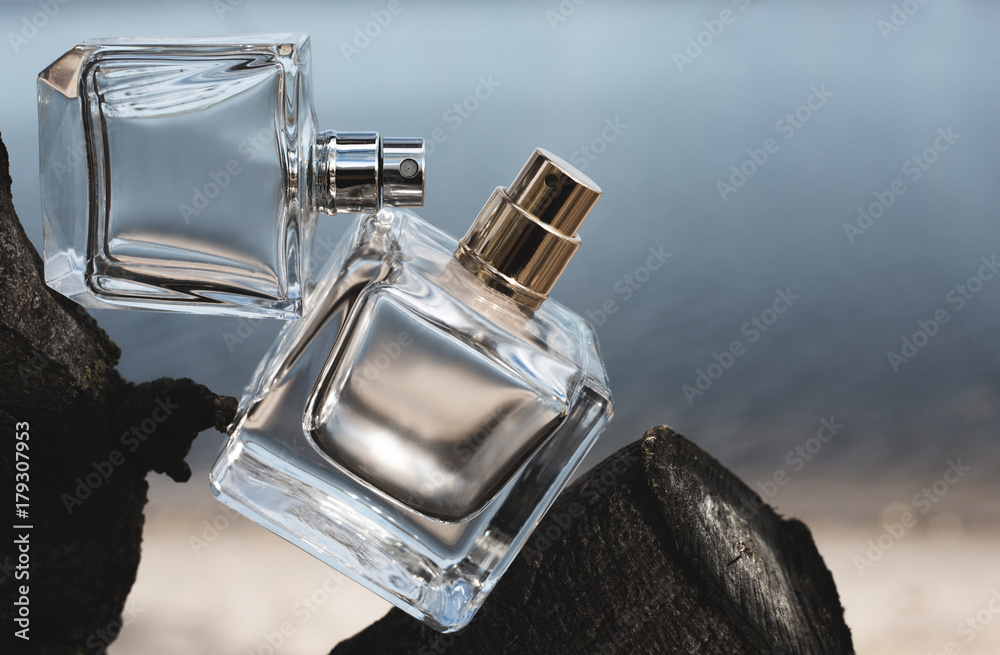 Two bottle of perfume on blue background - obrazy, fototapety, plakaty 