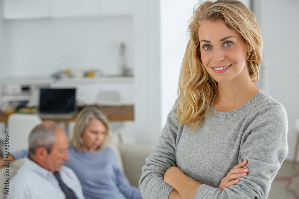 adult daughter with parents in background adult daughter with parents in background
