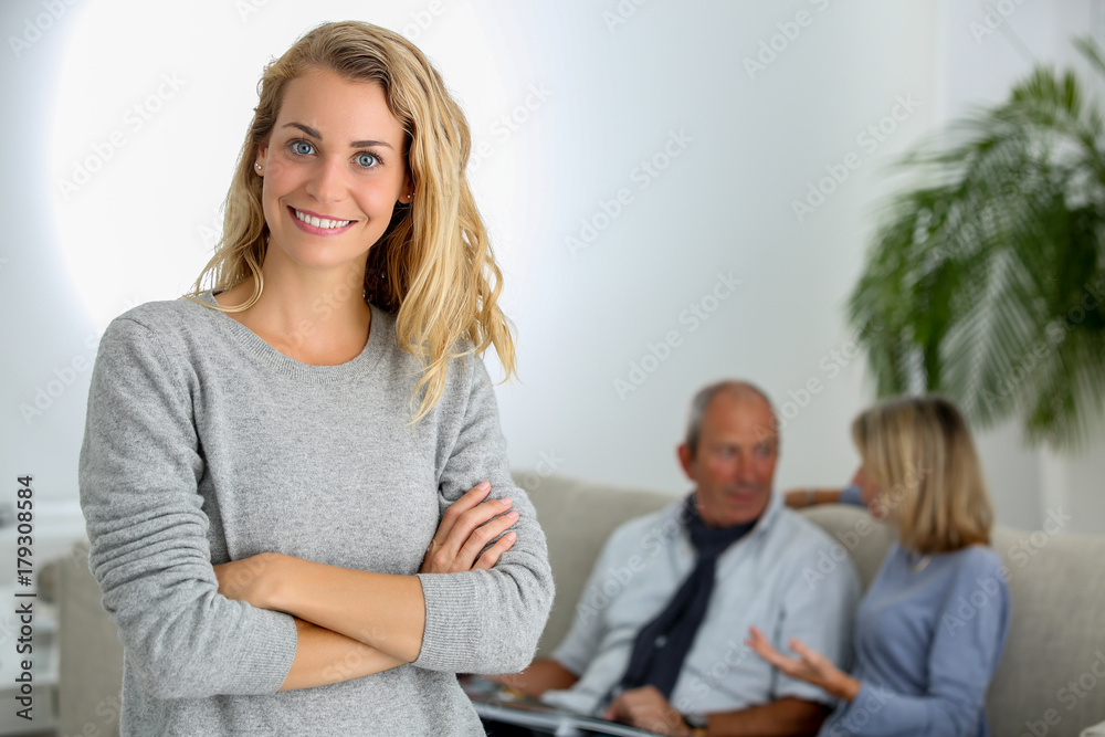 adult daughter with parents in background adult daughter with parents in background