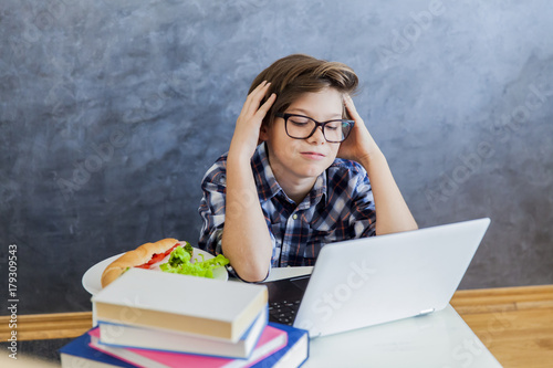 Teenage boy working on lapt...