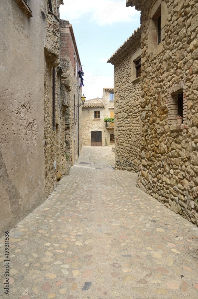 Medieval cobblestone alley in Peratallada, Girona, Spain