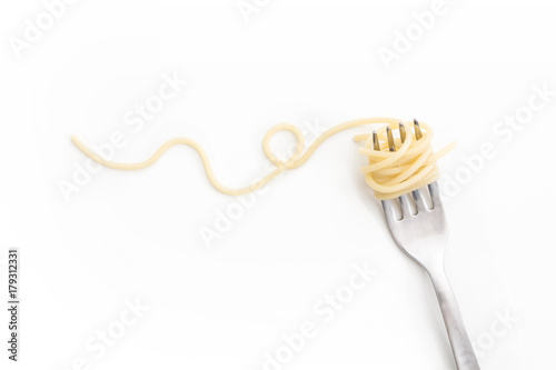 Plain cooked spaghetti pasta on fork with swirl, on white background.