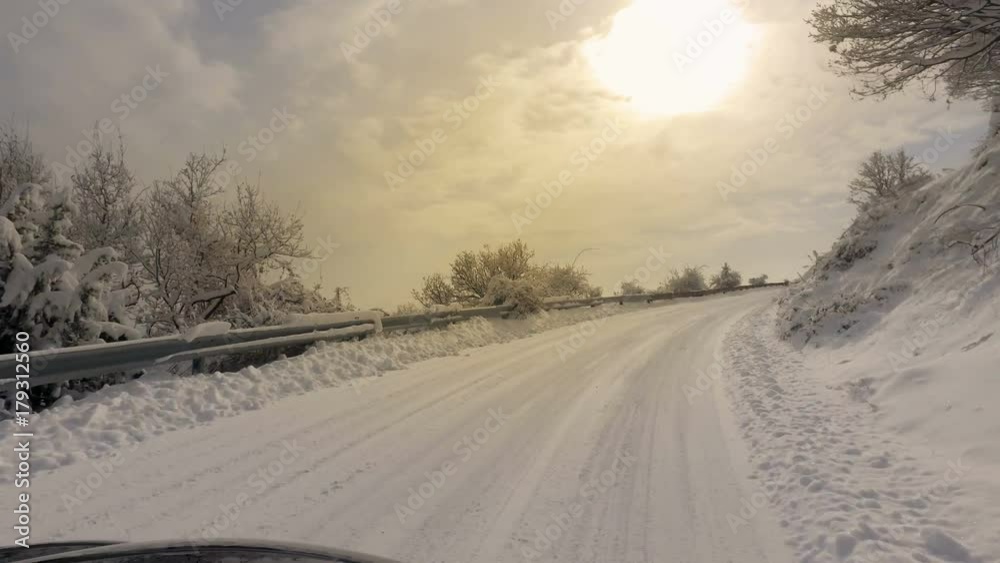 Car and falling snow in winter on forest road with much snow Car and falling snow in winter on forest road with much snow
