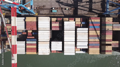 underway - LARGE container ship fully loaded with containers and cargo - aerial 4k view top down