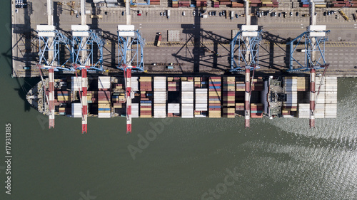 underway - LARGE container ship fully loaded with containers and cargo - aerial 4k view top down