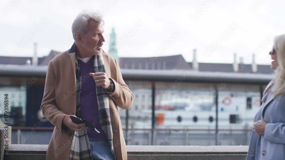 Mature man awaits his female companion before heading off