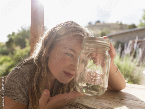 Caucasian girl looking at jar