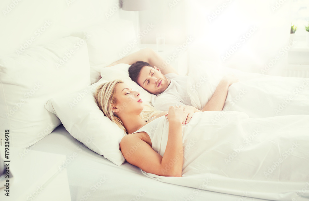 happy couple sleeping in bed at home happy couple sleeping in bed at home
