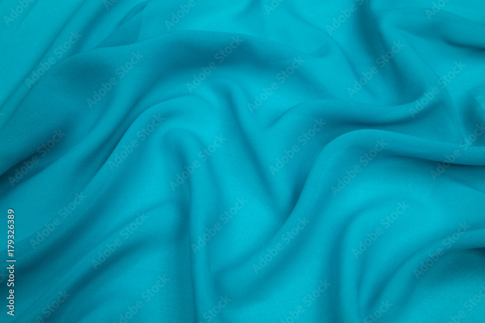 a delicate faux silk fabric turquoise blue lined with soft folds a delicate faux silk fabric turquoise blue lined with soft folds