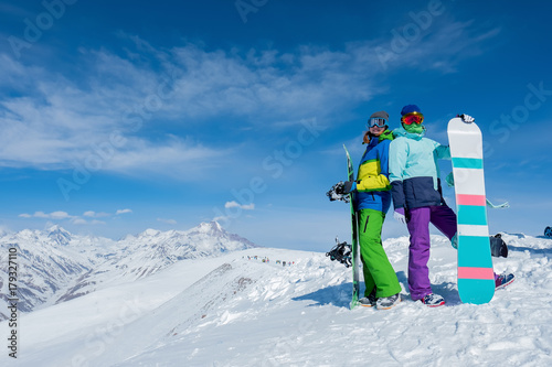 Two girls are holding snowboard boards. Winter. The mountains photo