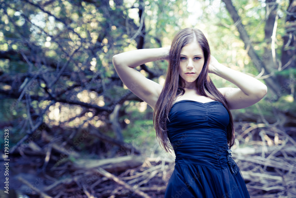 Beautiful young woman in a stream posing displays elegance and confidence Beautiful young woman in a stream posing displays elegance and confidence