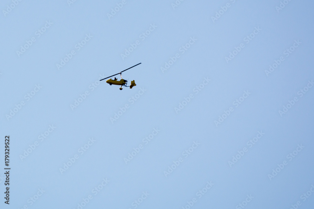 Fototapeta premium Gyrocopter flying in the sky