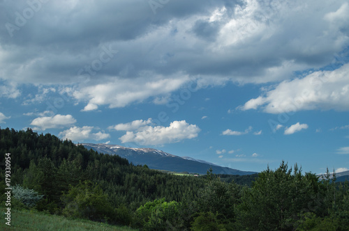 Snowy peak and green hills