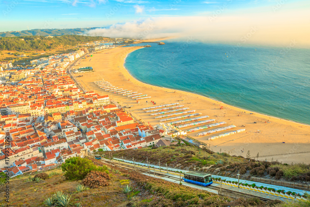 View of Nazare cabins train Funicular. Nazare in Portugal is the most popular seaside resorts in Atlantic coast. Nazare Skyline and beach waterfront from Nazare Sitio.