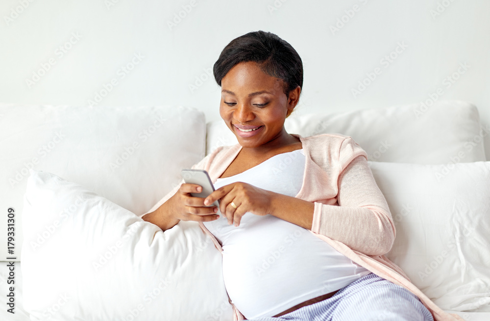 happy pregnant woman with smartphone at home happy pregnant woman with smartphone at home