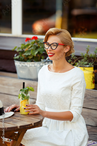 Sexy blonde girl with glasses in retro look