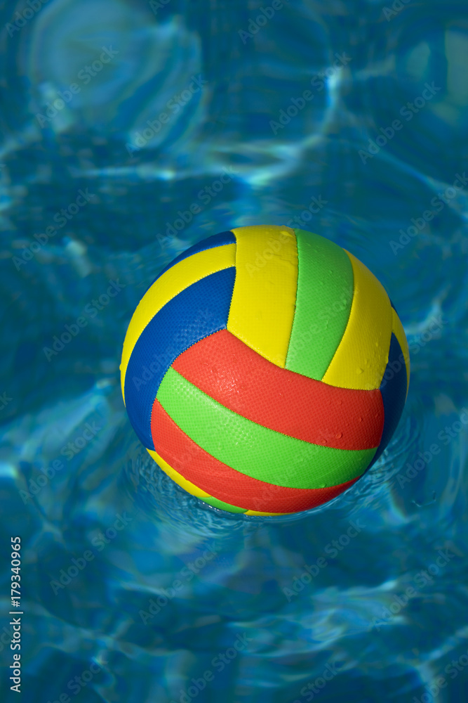 Brightly coloured football in water