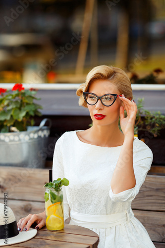 Sexy blonde girl with glasses in retro look