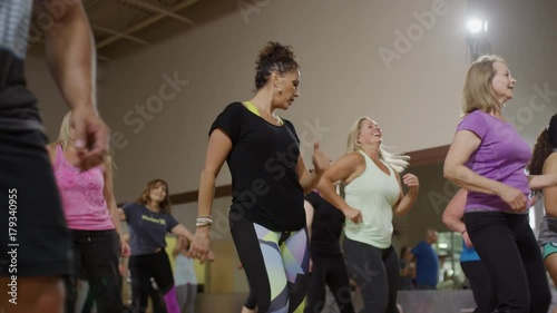 Medium panning shot of people dancing in exercise class / Orem, Utah, United States