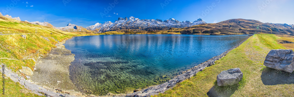 Naklejka premium Crystal clear Melchsee and Swiss Alps panorama from Melchsee Frutt, Obwalden, Switzerland, Europe