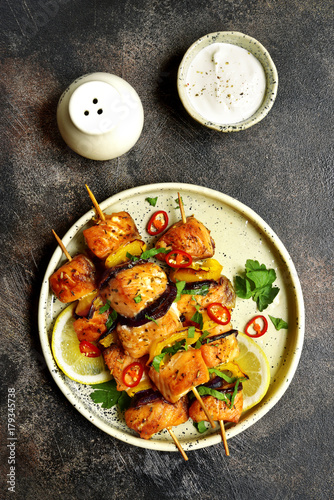 Grilled salmon kebab on a craft plate .Top view .