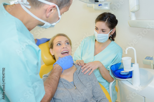 Lady having teeth inspected by dentist
