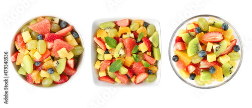Bowls with fruit salads on white background
