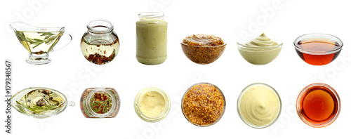 Delicious dressings for salad on white background