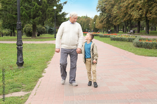 Elderly man with grandson in park