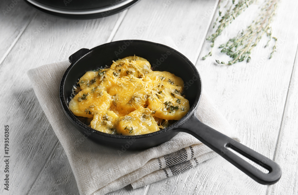 Frying pan with potato casserole on table Frying pan with potato casserole on table