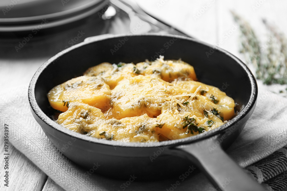 Frying pan with potato casserole on table Frying pan with potato casserole on table
