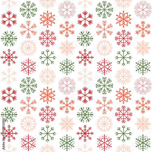 Seamless vector pattern with red, pink and green snowflakes for Christmas and winter holiday product designs, backgrounds and wrapping paper