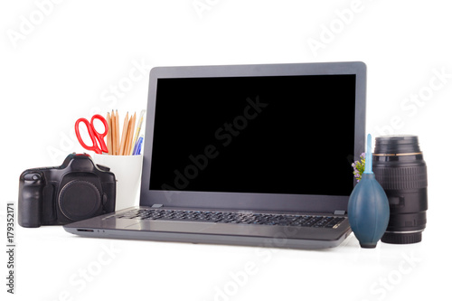 Work place with laptop and camera equipment. Objects on the isolated white background with clipping path and copy space. photo