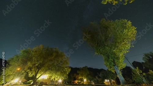 Night motion timelapse of trees , milky way and stars at Lake Henshaw, Santa Ysabel, California, United States photo